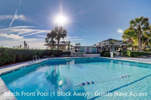 a swimming pool at a resort with palm trees at Near Beach & Coligny Plaza, Pool, Hot Tub, Patio in Hilton Head Island