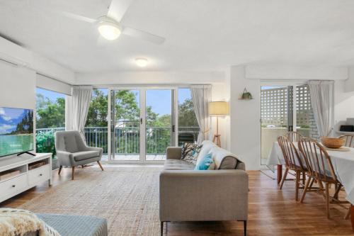 a living room with a couch and a tv at Windbourne Unit 6 101 The Esplanade Golden Beach in Golden Beach