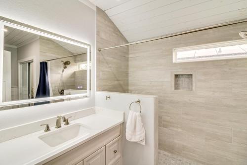 a bathroom with a sink and a mirror at 5 Mi to Dtwn Bright Home with Yard in Pensacola! in Pensacola
