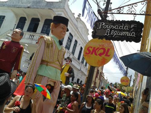 a crowd of people walking down a street withumedumed people at Pousada Alquimia in Olinda