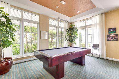a pool table in a room with windows at Resort Condo about 1 Mi to Boynton Beach Access! in Boynton Beach