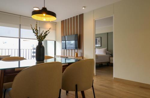 a living room with a dining room table with chairs at Pod by Wynwood House in Lima