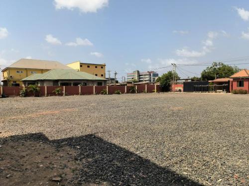 a shadow of a fire hydrant on a parking lot at Empress White House Accra in Tema
