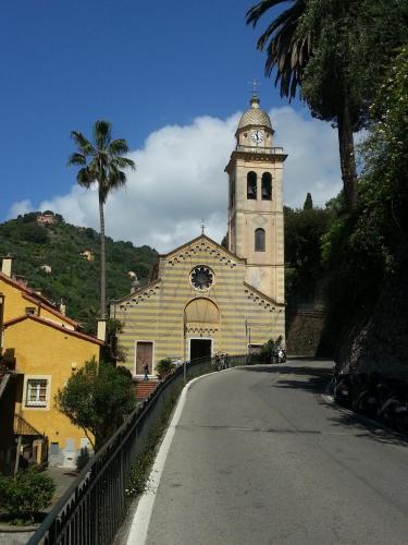 a church with a clock tower on top of a street at Civico 3 in Portofino