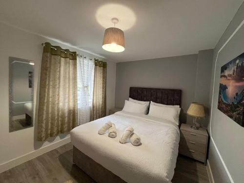 a bedroom with a bed with two slippers on it at Dream flat in Dundry