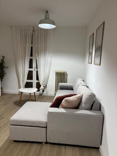 a living room with a couch and a chair at Ruavieja, camino y vino in Logroño