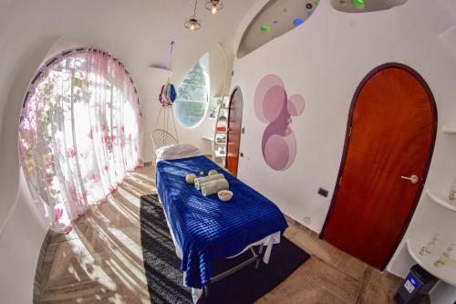 a childs room with a blue blanket on a bed at Wifala Harmony Hotel in Urubamba