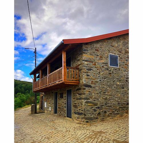 a building with a balcony on the side of it at Casa da Lúcia in Bragança