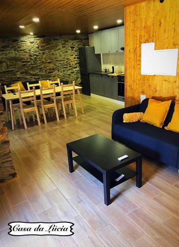a living room with a couch and a table at Casa da Lúcia in Bragança