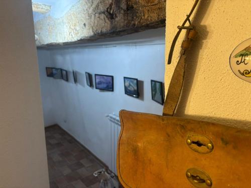 a room with a wall with pictures on it at postAielli - Arte, Natura e Relax in Aielli