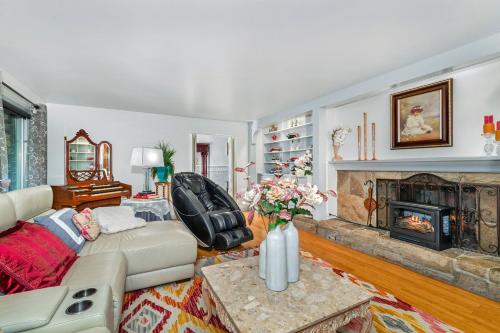 a living room with a couch and a fireplace at Sanctuary-5BR Home for Extended Stays & Family Comfort in Spokane