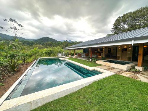a swimming pool in the yard of a house at Chachagua Rainforest Hotel & Hot Springs in Fortuna