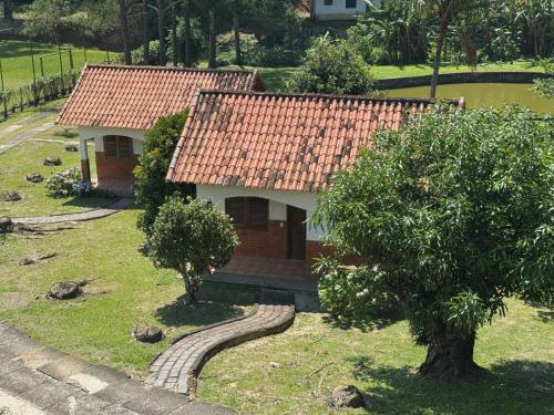 a small house with a red tile roof at Re-Canto dos Pássaros - Mendes in Mendes