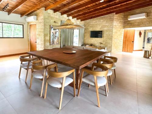 a dining room with a large wooden table and chairs at Chachagua Rainforest Hotel & Hot Springs in Fortuna