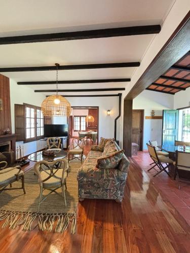a living room with a couch and a table at La Danesa - Casa de campo en la naturaleza a 25 min del centro in Tandil