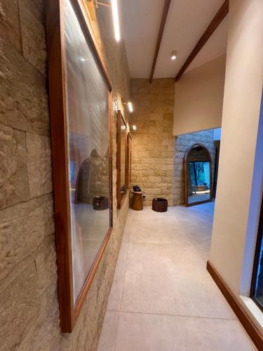a hallway of a house with a stone wall at Chachagua Rainforest Hotel & Hot Springs in Fortuna