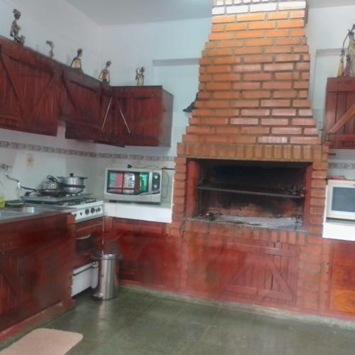 a kitchen with a brick oven in a kitchen at Camilita 1 y Aurorita1 in Encarnación