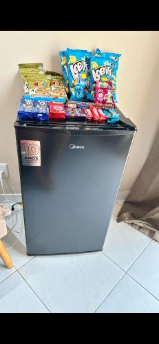 a refrigerator with chips and snacks on top of it at Casa para cop 30 in Ananindeua