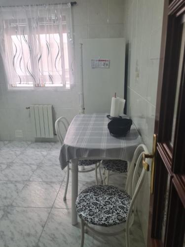 a table and chairs in a room with a window at Dreams Work - Your refuge in Burgos in Burgos