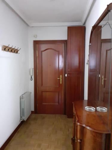 a room with a wooden door and a wooden table at Dreams Work - Your refuge in Burgos in Burgos