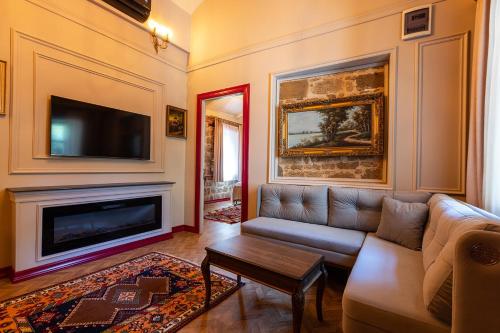 a living room with a couch and a fireplace at Orion Adatepe in Adatepe