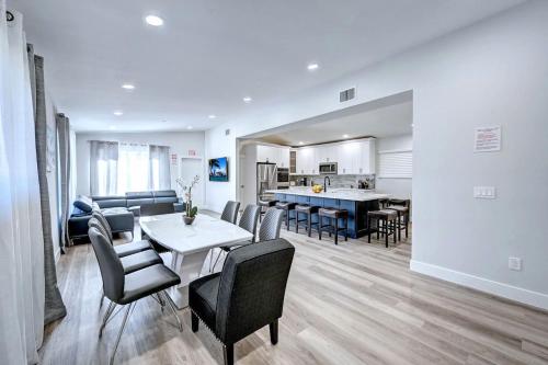 a living room with a table and chairs and a kitchen at Walk to Beach Luxury 4BR & 4BA Villa Hollywood Lakes in Hollywood