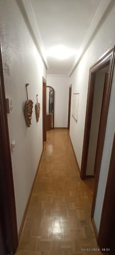 a hallway with a long corridor with doors and a floor at Dreams Work - Your refuge in Burgos in Burgos