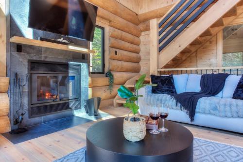 a living room with a couch and a fireplace at Tremblant chalet O-Spa in Lac-Superieur