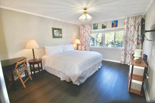 a bedroom with a large white bed and a window at Seaside Escape in Fort Pierce