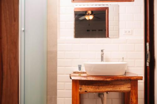 a bathroom with a sink and a mirror at Beach Break Hotel & Surf Camp de Playa Venao in Playa Venao