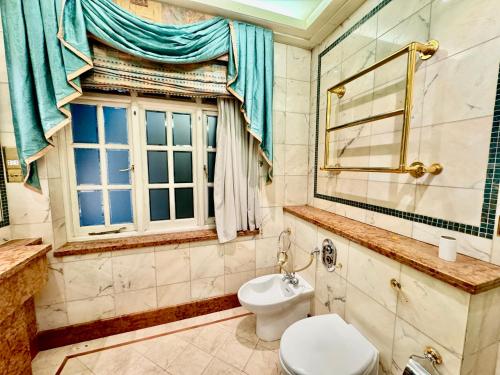 a bathroom with a toilet and a window at The Bishop in London