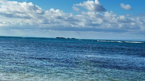 a large body of water with two islands in the distance at Casa Ballenas1 SF in Las Terrenas