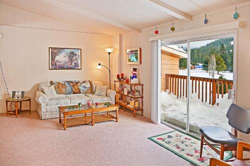 a living room with a couch and a table at Huckleberry Cabin in Dryden