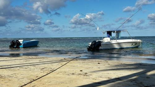 a boat sitting in the water on the beach at Casa Ballenas1 SF in Las Terrenas