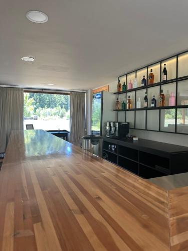 a dining room with a large wooden table in a room at El Pedregoso Flights & Lodge in Cholila