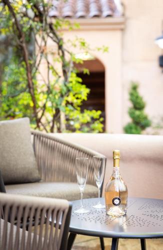 a bottle and two glasses sitting on a table at Fairmont Sonoma Mission Inn & Spa in Sonoma