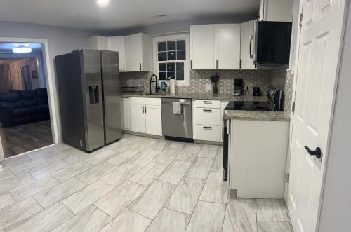 a kitchen with white cabinets and stainless steel appliances at Spacious 3 Bedroom , 1 Bath House Pet friendly in Red Top