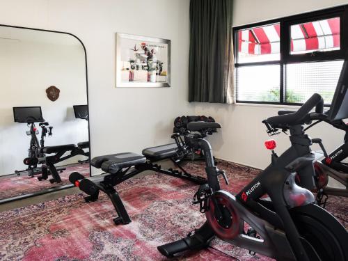 a room with two exercise bikes and a mirror at Palihotel Melrose in Los Angeles
