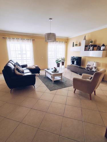 a living room with two couches and a table at DOWNTOWN-GuestHouse in Olhão