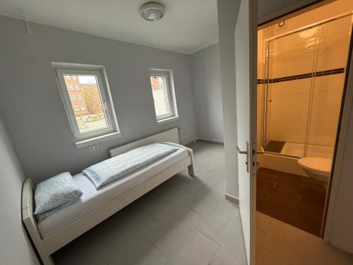 a small bathroom with a bed and a sink at Rest Best L97 in Hamburg