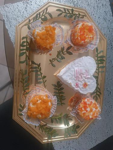 a plate of food with oranges on a table at Maison chaleureuse à Capendu avec cheminée et jardin in Capendu