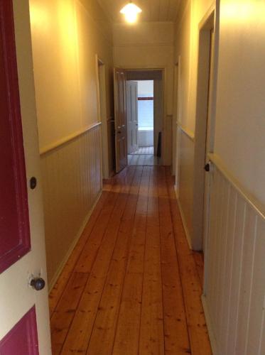 a hallway with a wooden floor in a house at Pemberton in Beechworth