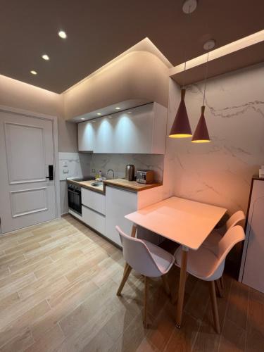 a kitchen with a wooden table and chairs in a room at The Wish Houses in Golem
