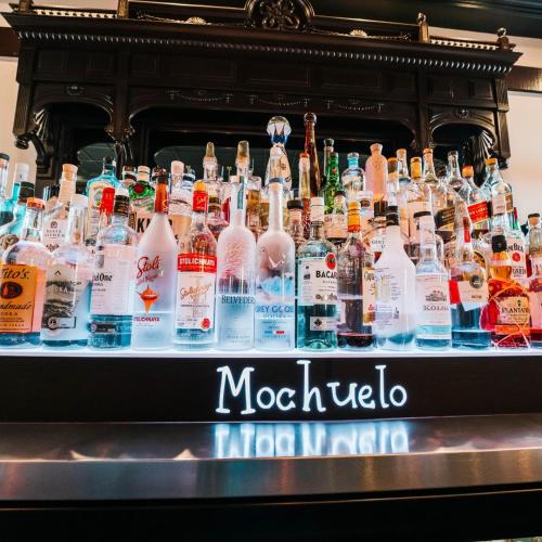 a display of bottles of alcohol on a table at Hotel Piccadilly in Fresno