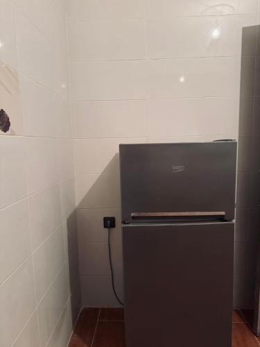 a refrigerator in a room with a wall at Apartment in front sania Ramel Airport 3 min walking in Tetouan