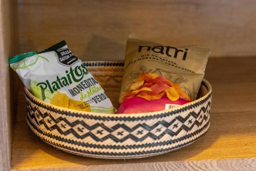 a basket filled with chips and other snacks on a shelf at Pao Pao Hotel Islas del rosario in Isla Grande