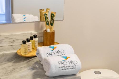 a bathroom with towels and toothbrushes on a counter at Pao Pao Hotel Islas del rosario in Isla Grande
