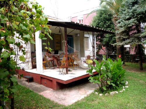 a porch of a house with a table and chairs at Vintage Summer House in Budva