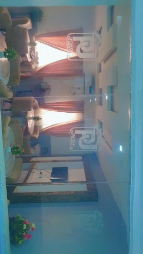 a refrigerator filled with lots of plants and a light at Pollyjolly Hotel And Suites in Oba Ile