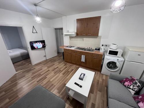 a small kitchen with a couch and a stove top oven at 1 bedroom apartment in Neepsend